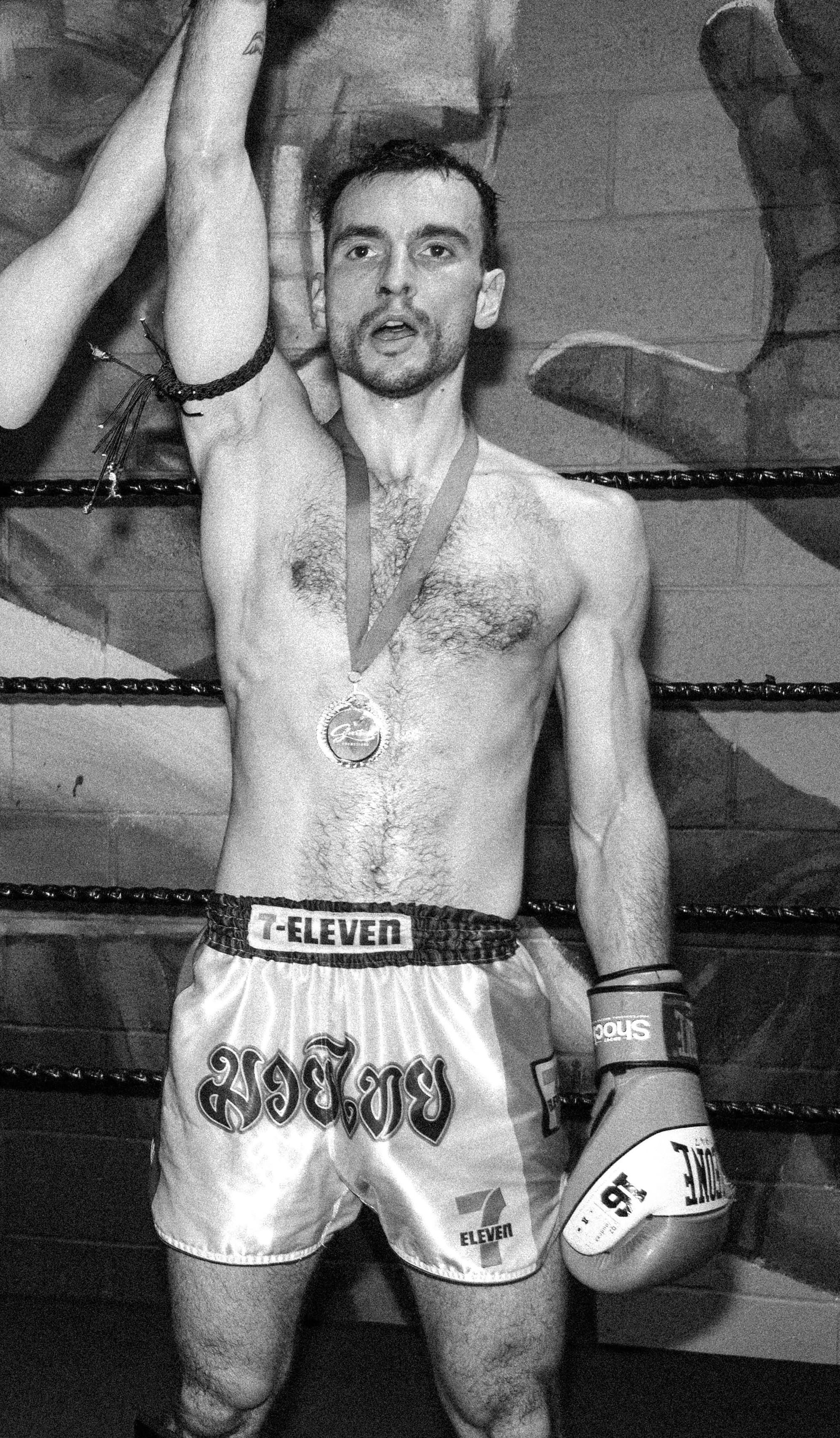 Yeuang Kraai fighter celebrating a victory with a medal in the ring